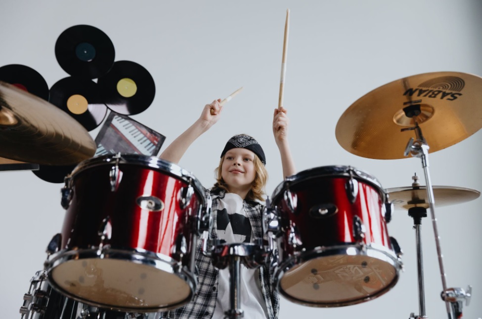 a kid plays drums